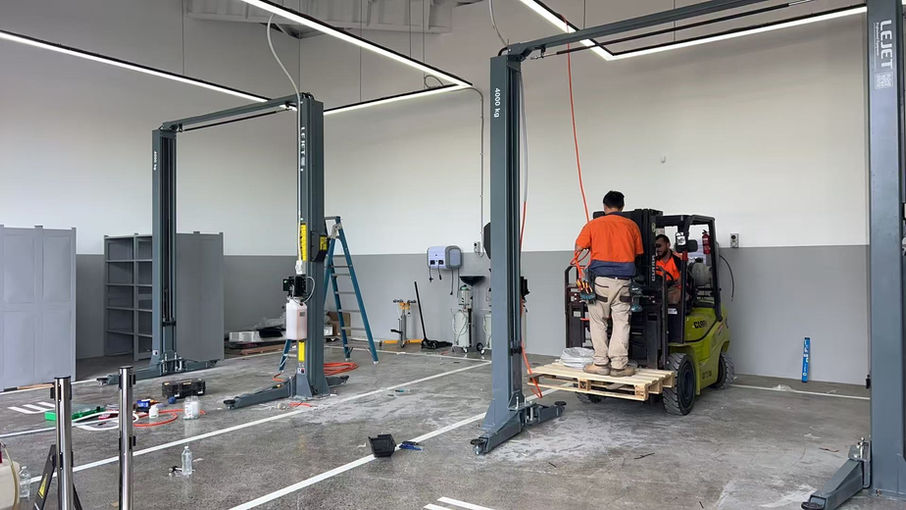 Two-post vehicle hoist being installed at the BYD Nowra workshop