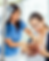 A nurse aids a parent nursing their newborn. Bright hospital setting with an IV stand in view.