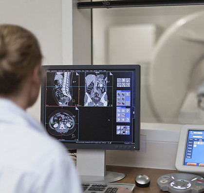 Doctor Operating CT Scanner