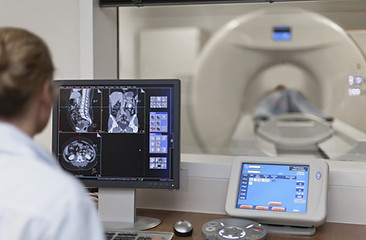 Doctor Operating CT Scanner