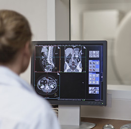 Doctor Operating CT Scanner