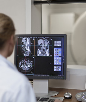 Doctor Operating CT Scanner