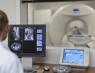 Doctor Operating CT Scanner