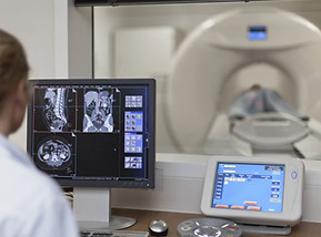 Doctor Operating CT Scanner