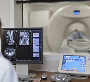 Doctor Operating CT Scanner