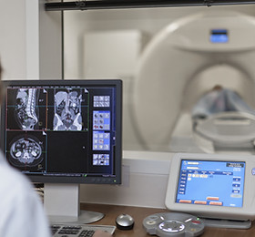 Doctor Operating CT Scanner