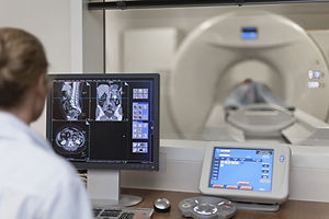 Doctor Operating CT Scanner