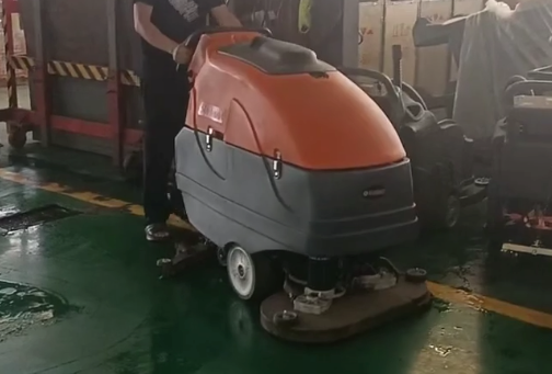 High angle view of SunMax scrubber cleaning a warehouse floor efficiently