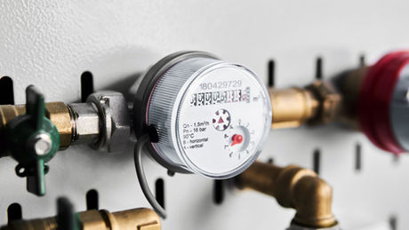 Water submeter installed on plumbing line for multi-tenant submetering and unit-level water tracking