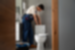 A man checking a toilet bowl