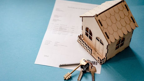 a house, keys and a document