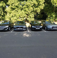 Four taxi cars parked front view