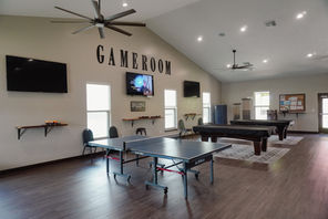 Game room with ping pong, pool tables, and TVs