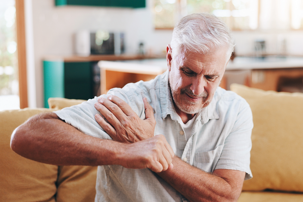 Senior man holding arm in pain; Ashford Pain Solutions for relief