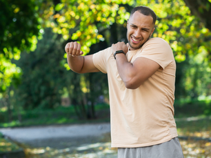 Man holding shoulder in pain