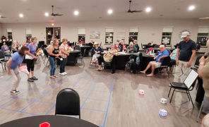 Residents enjoying indoor shuffleboard game
