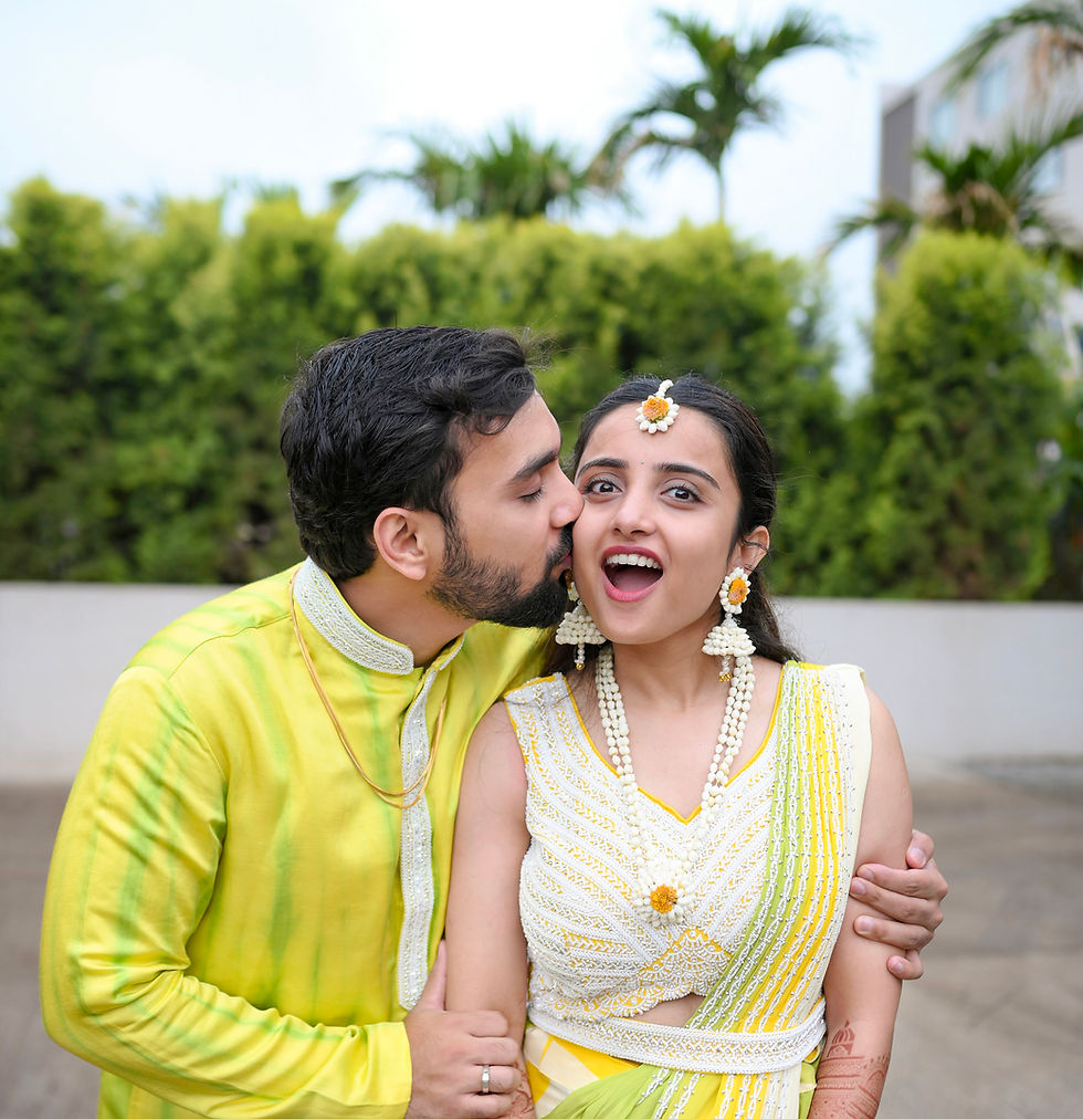 Groom kissing bride's cheek in wedding photography.