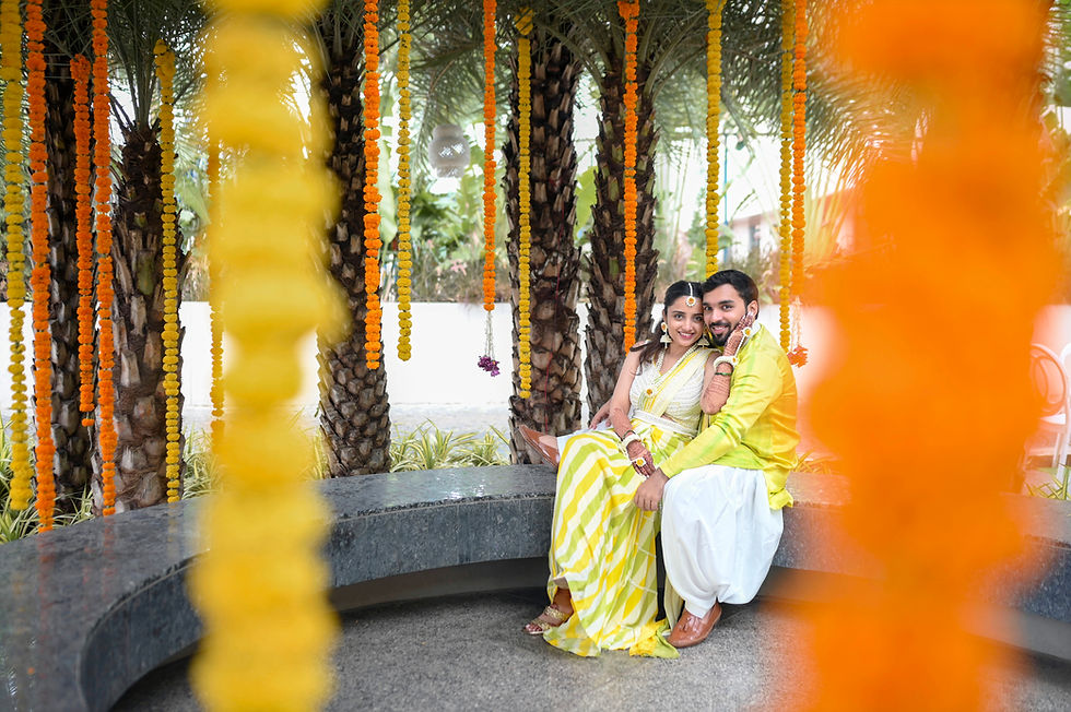 Couple posing for wedding photography amidst marigolds.
