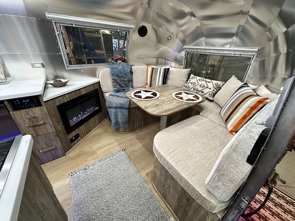 Close-up view of hands installing peel-and-stick backsplash tiles in an RV kitchen