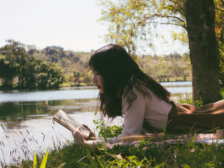 Woman reading Shakespeare by a river