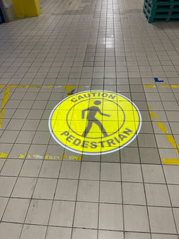 SafetyCast Projected "Caution" Sign on the rough floor