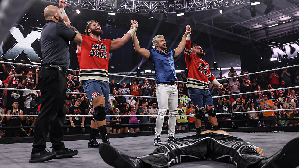 Joe Hendry with Hank And Tank after they got the victory in the Eight-Man Tag Team Main Event against DarkState to close out NXT. (Photo by WWE)