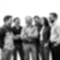 a luxury black and white image of a group of professional engineers all laughing and smili