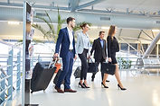 Business people as a business team with luggage on business trip in airport terminal.jpg