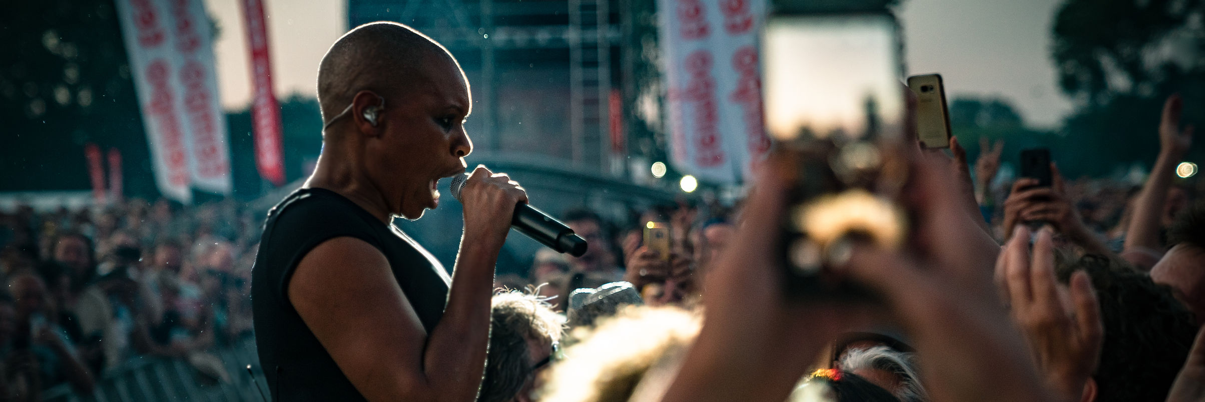 A performer sings next to the crowd at Parkpop