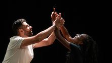 two actors dance together