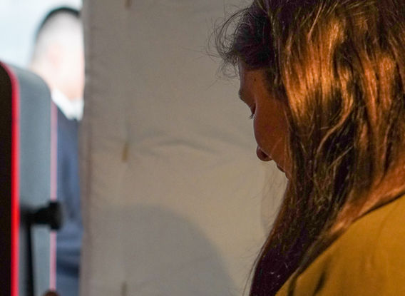 Young girl looking at her photo booth prints.