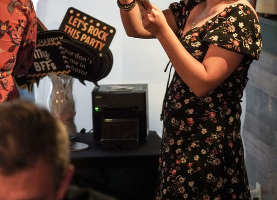 Young woman looking at her prints from photo booth