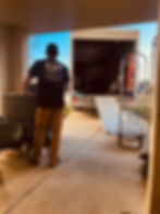 Front Line Movers loading a moving truck from a large home relocation
