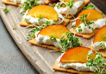 Cottage Cheese and Nectarine Wedges on Melba Toast Appetizer Served with Broccoli Microgreens
