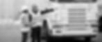 two-technicians-discussing-maintenance-contracts-in-front-of-a-comemrcial-truck