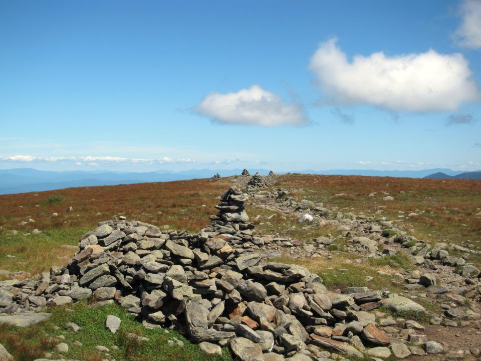 Rocky pathway leading to slightly cloudy blue skies