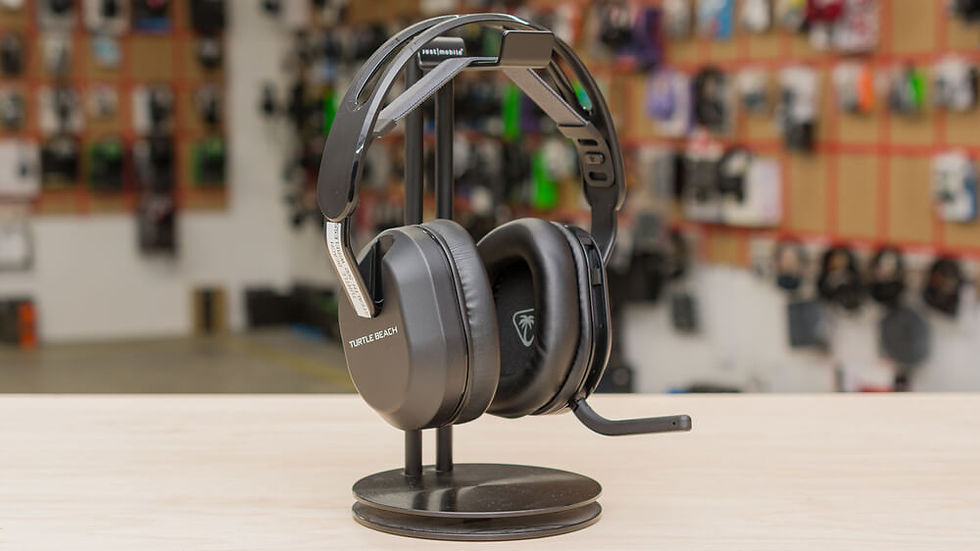 Turtle Beach over-ear gaming headset on a stand on a table, with a blurred store wall of accessories in the background.