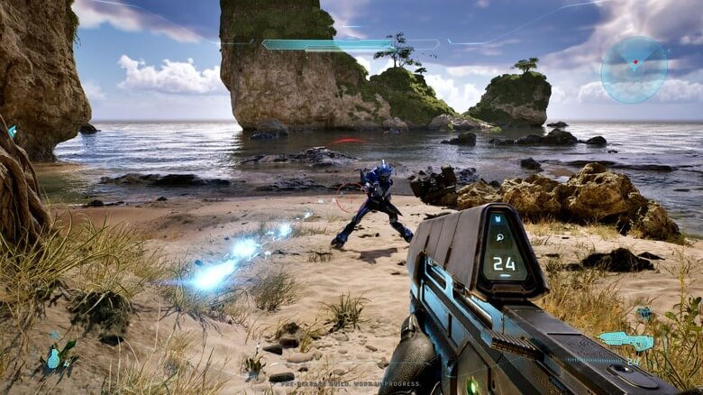 First-person shooter on a tropical beach, aiming at a blue alien enemy near rocky sea cliffs under a bright sky.