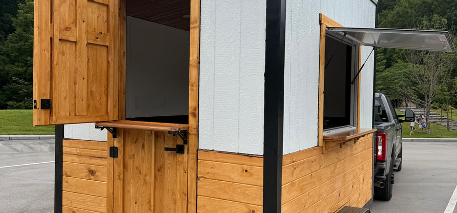 The Cottage
The Cottage is a handcrafted mobile coffee trailer designed for entrepreneurs who want a business that stands out. With its timeless cottage-inspired design, premium materials, and functional layout, it’s built to help you create an unforgettable customer experience while giving you a workspace you’ll love.
Every Cottage is built in East Tennessee with quality craftsmanship and attention to detail. The interior is designed for efficiency, providing ample workspace while maintaining an open, inviting feel. Whether you’re serving coffee, dirty sodas, teas, lemonades, baked goods, or specialty beverages, The Cottage can be customized to fit your business.
Standard Features
Cottage-inspired exterior design
Commercial-ready 240V electrical system
Fresh and gray water systems
Three-compartment sink and separate handwash sink
Composite countertops
Durable waterproof interior finishes
Rooftop air conditioner
LED interior and exterior lighting
Dedicated space for commercial equipment
Nationwide delivery available
Built Around Your Business
No two businesses are the same, and your trailer shouldn’t be either. We work with every customer to customize the layout and options to match your menu, equipment, and workflow, helping you create a trailer that’s both beautiful and practical.
When you invest in The Cottage, you’re getting more than a trailer—you’re getting a handcrafted business built to help you make a lasting first impression.
Ready to start your mobile coffee business? Contact us today to discuss your custom build.