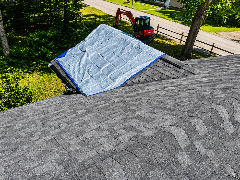 Blue tarp covering storm damage on a shingle roof
