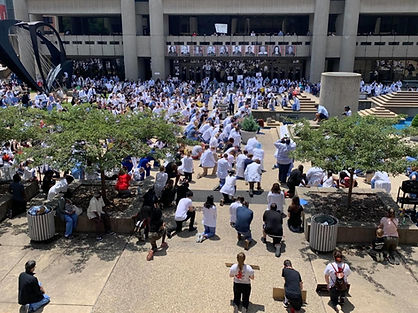 The University of Louisville School of Medicine medical community kneel during the White Coats for Black Lives Rally