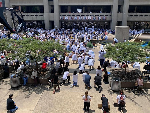 The University of Louisville School of Medicine medical community kneel during the White Coats for Black Lives Rally