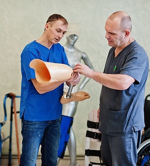 two-prosthetist-man-workers-with-prosthetic-leg-working-laboratory.jpg