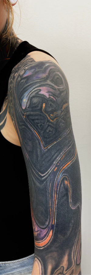 settled black out tattoo and color overlay healed