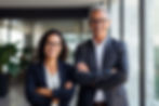 Two wealth advisors smiling and looking at the camera.