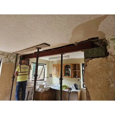 builder knocking through a wall