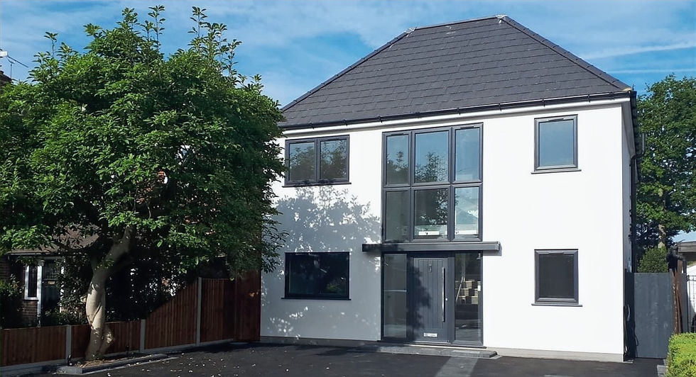Large modern white house with a black roof and black frame windows.
