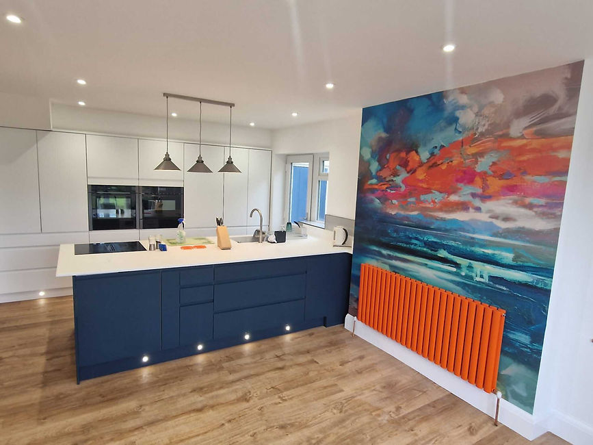 blue and white kitchen with a painted orange radiator