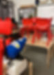 classroom with red chairs on wooden tables