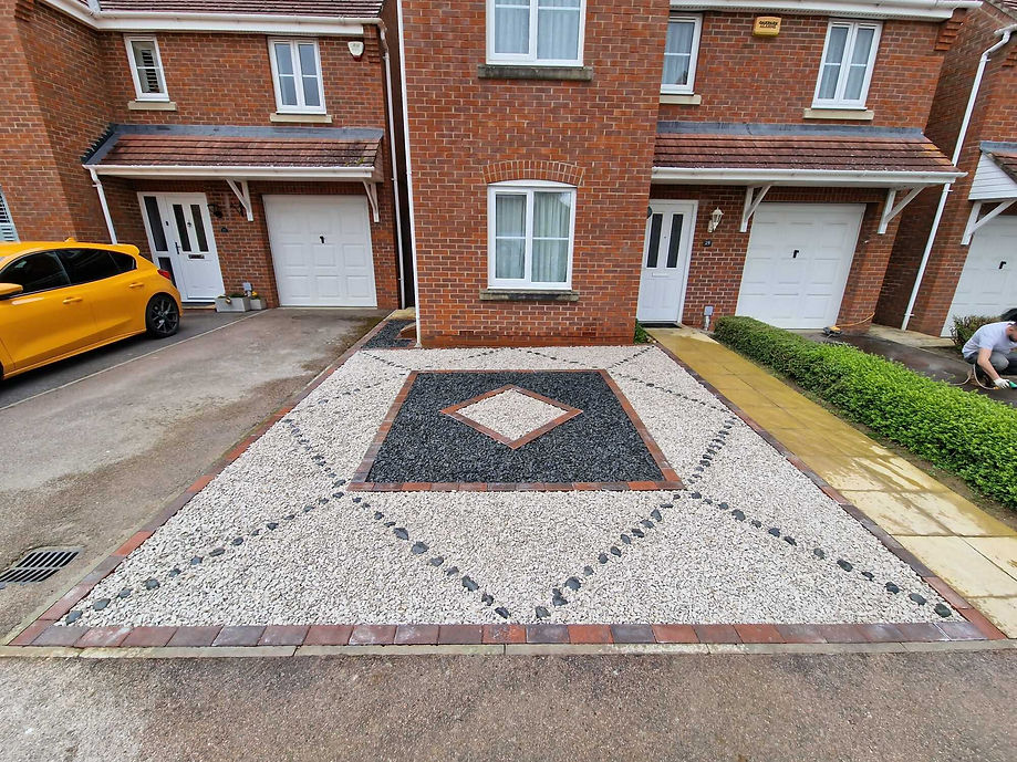light and dark pattern driveway in front of a house